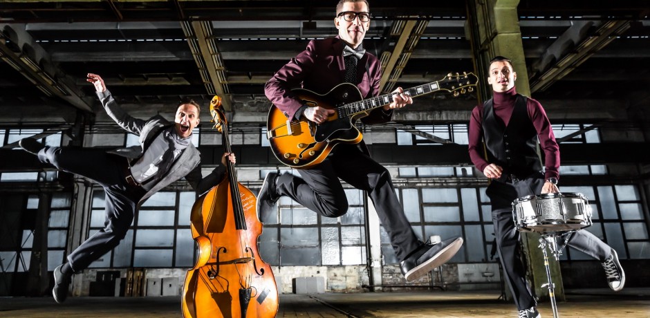 rock band jumps into the air in an industrial building